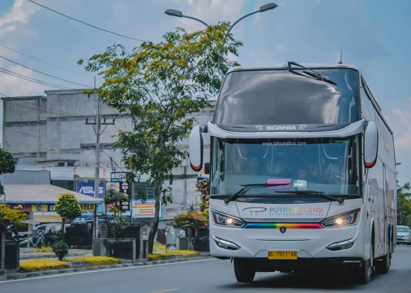 A white RouteLine coach on a city street